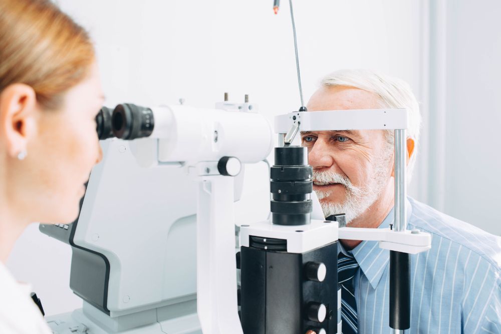 Patient receiving an eye exam with a slit lamp during a retina specialist visit.