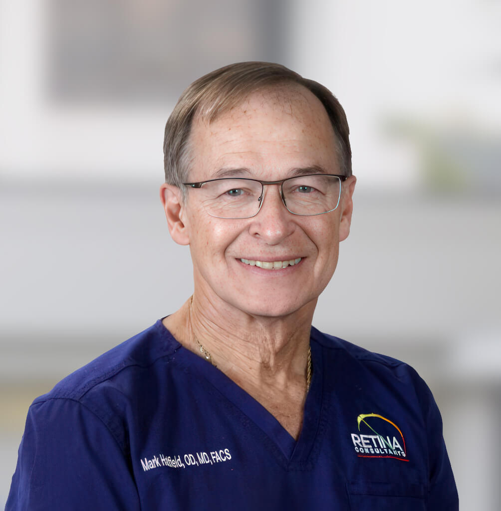Portrait of Mark Hatfield, MD, FACS, retina specialist in blue medical scrubs.