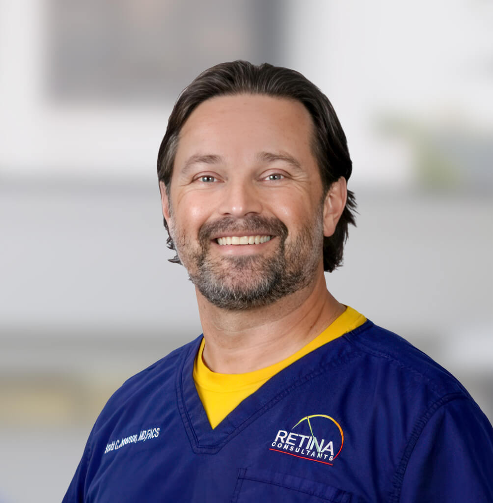 Portrait of Scott C. Jamerson, MD, FACS, retina specialist in blue medical scrubs.
